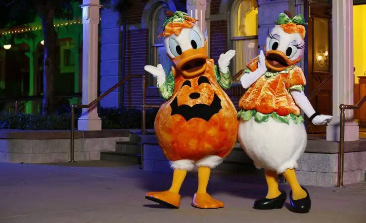 Donald and Daisy in Halloween outfit greet visitors at the entrance 