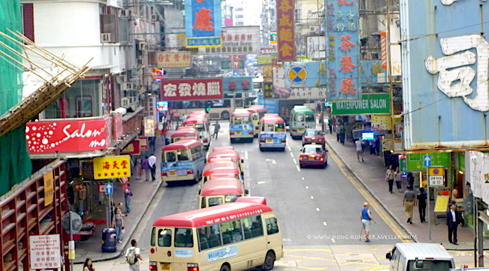Busy Hong Kong Street with many Transportation Options: buses, mini buses, etc